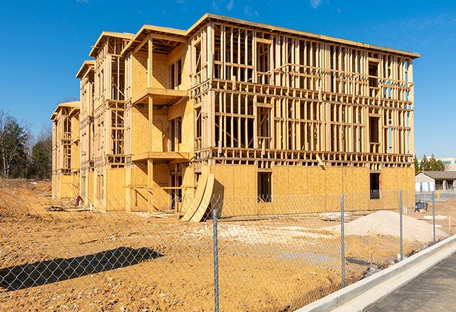 a close-up of temporary chain link fences enclosing a construction site, signaling progress in the project's development in Longwood